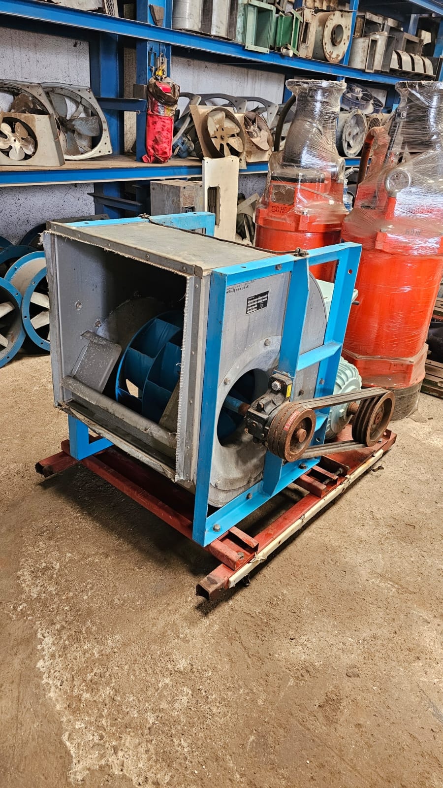Industrial blower surrounded by machinery parts