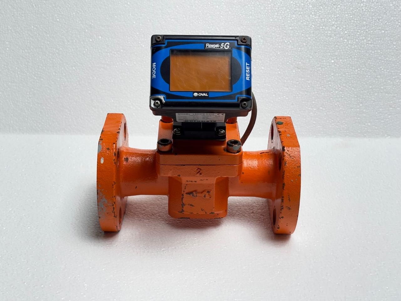 Orange industrial flow meter with digital display