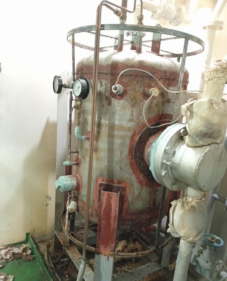 Industrial pressure vessel with gauges and piping