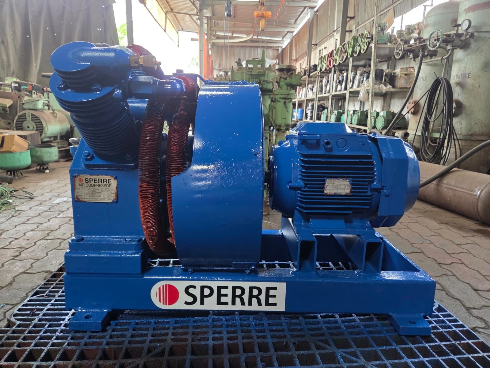 Blue industrial air compressor in a workshop