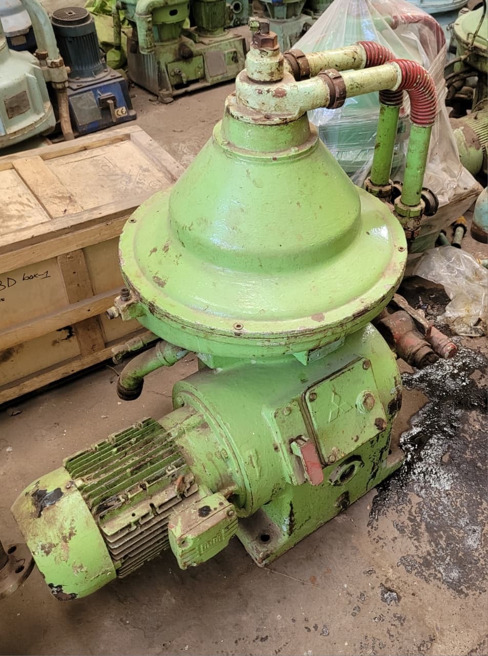 Industrial green pump machinery in a workshop